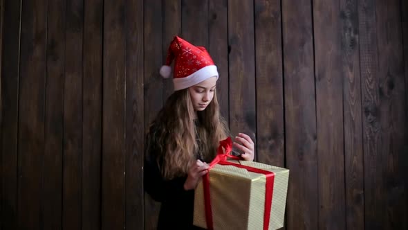 Happy child with red box, Christmas miracle, magic gift box and a child baby girl