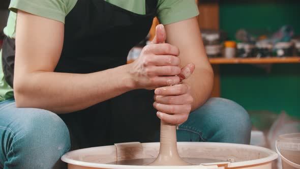 Pottery - Potter Master Is Pulling Clay in Length on a Potter's Wheel with Both Hands