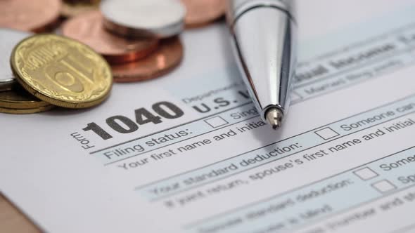 Close Up of a Tax Return Form and Pen on Table.