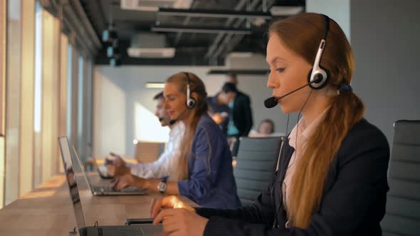 Handsome Woman Employee Operator Woman Agent with Headsets Working in a Call Center.