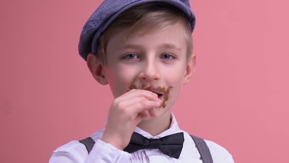Sweet-Tooth Boy Face Covered in Chocolate Looking at Camera, Overeating Sugar