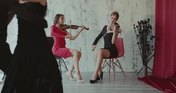 Beautiful View of Dancers Couple Perform Tango While Girls Play the Violin