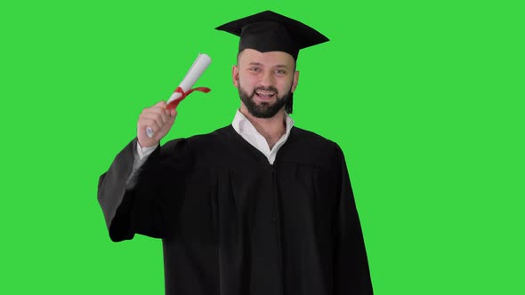 Young Smiling Man on His Graduation Day on a Green Screen, Chroma Key.