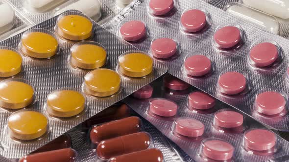 Closeup Shot of Different Pills Falling on Table with Tablets , Pharmaceutical Industry Concept