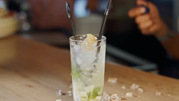 Ice poured in a glass of mojito