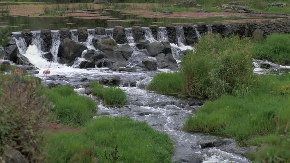 River Water Flowing Through Stone Weir Down Stream, SLOW MOTION