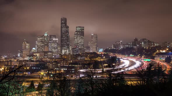 Time lapse of traffic on the freeway looking toward Skyscrapers in Seattle and Centurylink Field