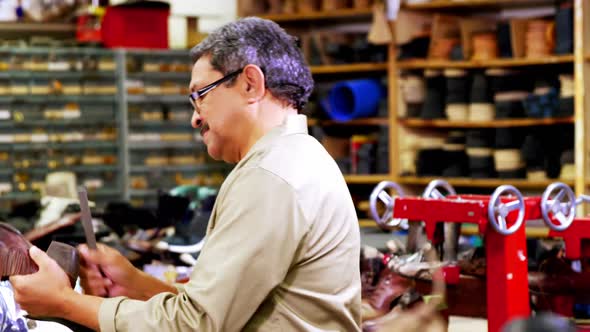 Cobbler examining a shoe