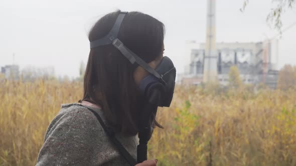 Woman In Gas Mask Respirator Walking Into Toxic Environment 1