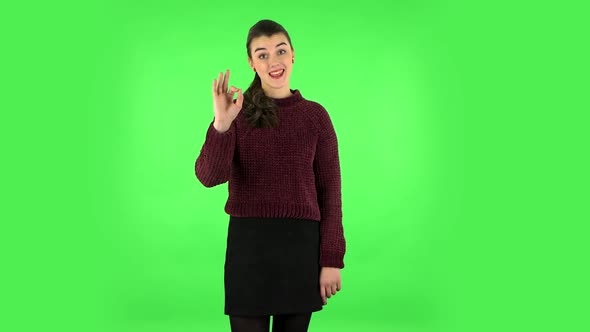 Smiling Girl Makes Sign Ok. Green Screen