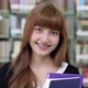 Slow motion of happy Asian beauty student with books smiling looking at camera in library. - VideoHive Item for Sale