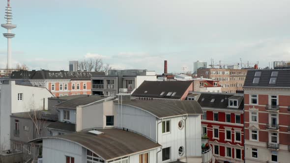 Ascending Aerial View of Houses in Residential Neighborhood Near Radio Telecommunication Tower in