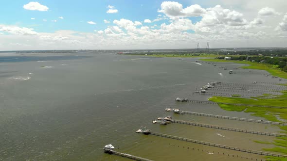 Aerial drone footage of coastal Mt. Pleasant, South Carolina with the Ravenel Bridge in the backgrou