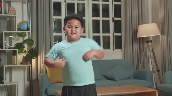 Asian Little Boy Dancing While Shooting Video Content For Social Networks