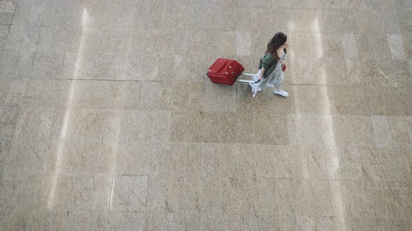 Young passenger with a suitcase at the airport 