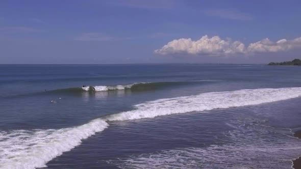 Super slow motion of surfers on the Keramas beach. Aerial view. Bali, Indonesia.