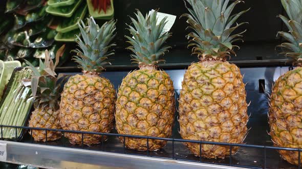 Faceless Woman Chooses Pineapple in Store Takes It