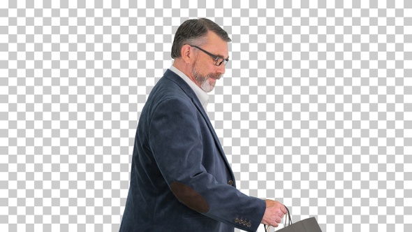 Senior business man walking with shopping bag, Alpha Channel