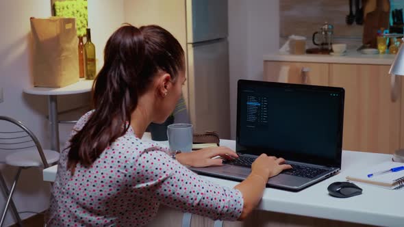 Back View of Woman Hacker Coding a Dangerous Virus