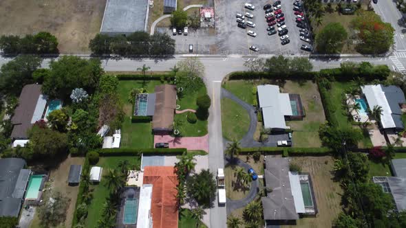 Aerial Tilt Reveal of a Rich South Florida Neighborhood with many Outdoor Pools