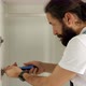 A Man is Installing the Door on the Wardrobe - VideoHive Item for Sale