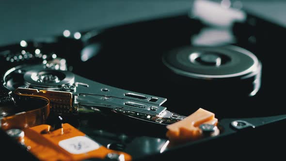 Opened Hard Disk Drive with Spinning Platter. Move of Writing Magnetic Head