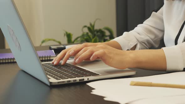 Female fingers typing on laptop keyboard. Business concept