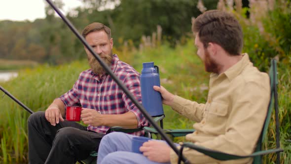 Friends Fishing and Drinking Tea From Thermos 21
