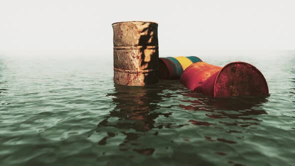 Old Rusty Barrels Oil in Sea Water Illustrates the Pollution of Environment