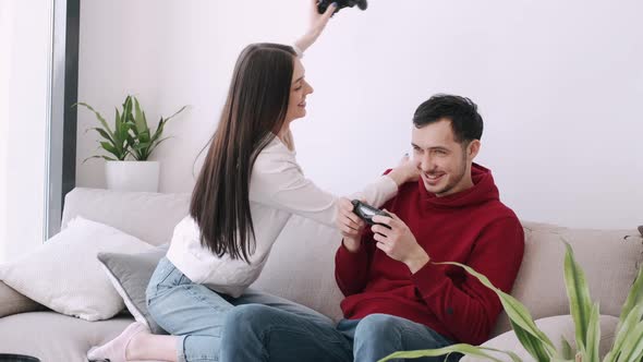 A Pretty Girl and a Boy Are Playing Video Games in the Living Room