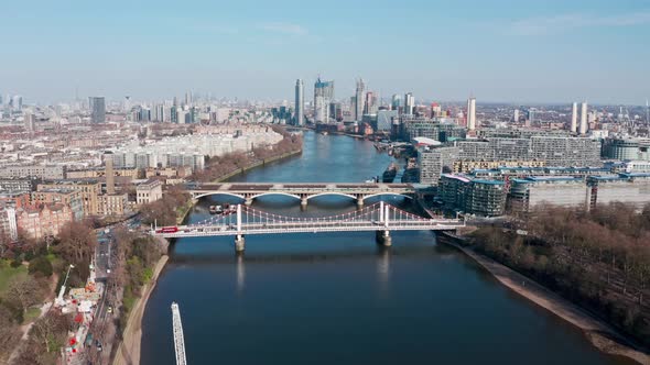 circling drone shot over London river thames at Battersea power station Chelsea Bridge