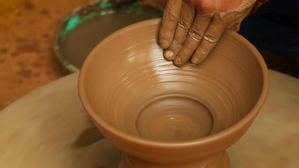 Potter at Work Makes Ceramic Dishes