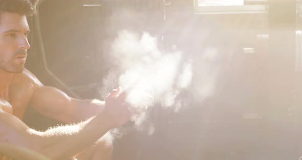 Man dusting his hands with chalk powder