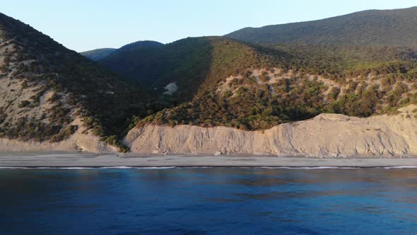 Aerial Flight with Drone DJI Over Beautiful Green Mountains and White Sandy Beach