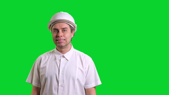 Young Male Engineer Standing and Smiling on Green Screen Background