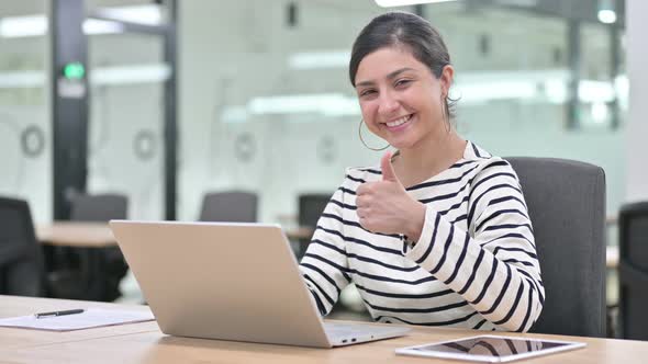 Positive Indian Woman with Laptop Doing Thumbs Up in Office 