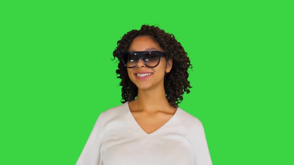 Happy African American Girl Chilling Wearing Sunglasses on a Green Screen Chroma Key