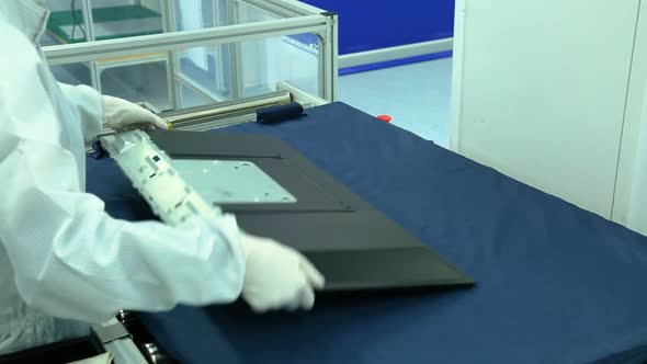 worker is assembling the back of a TV