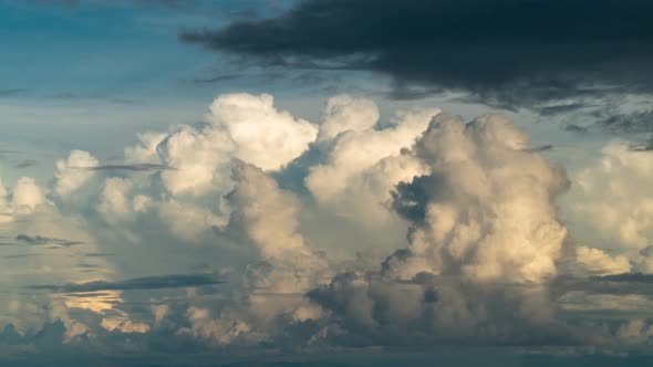 Dramatic cumulonimbus clouds form above ocean during dusk, timelapse