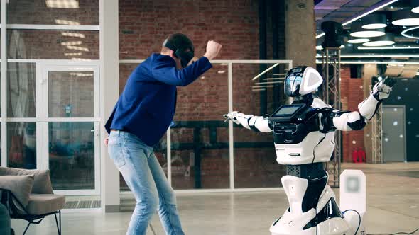 A Man in VRglasses is Dancing with a Robot