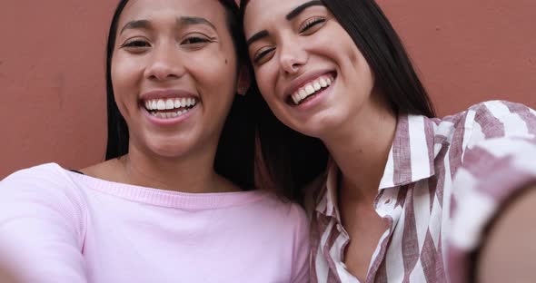 Cheerful young latin women making video with smartphone camera - Concept of friendship and happiness