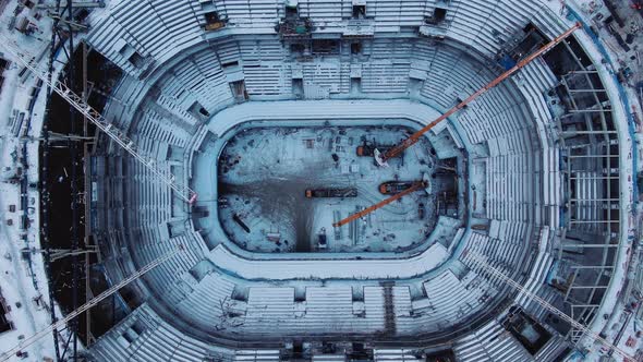 Place Inside Stadium Covered with Snow with High Cranes