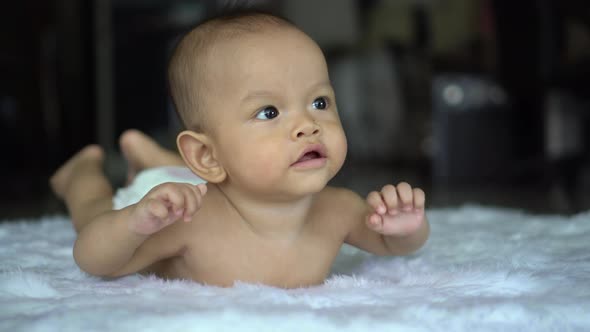 Happy portrait baby boy playing alone