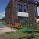 Strong Man in Shorts Cutting Grass Lawn Near Private Children Playground - VideoHive Item for Sale