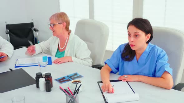 Medical Practitoner Talking with Colleague During Medicine Briefing