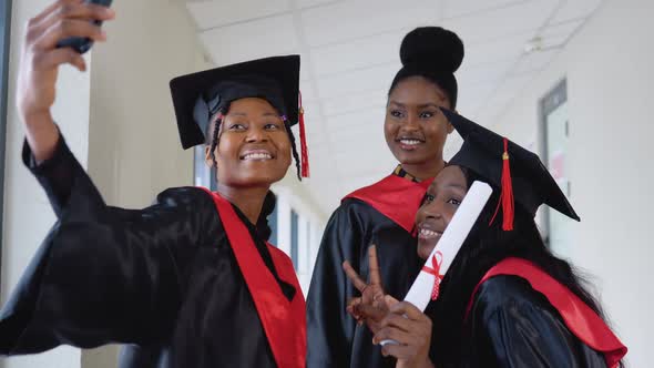 A Group of African American Students with Diplomas Make Selfie in the University Building