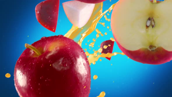 Red Apple with Slices Falling on Blue Background