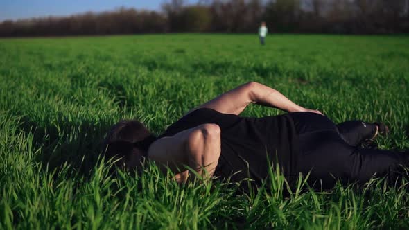 The Young Guy Assiduously Does Pushups on One Hand