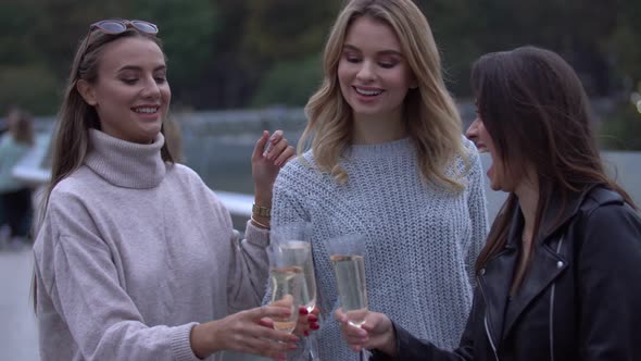 Girls Pour Champagne Into Glasses