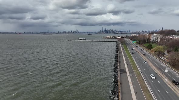 An aerial view over the waters of Upper Bay in Brooklyn NY. The drone camera dolly in along the Belt